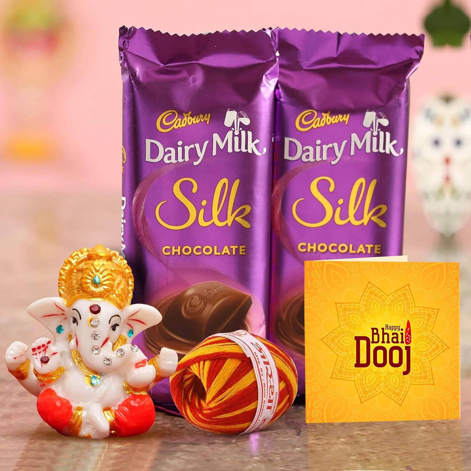 Bhai Dooj Gift Set for Brother with Dairy Milk Silk Chocolates Mini Ganesha Idol Statue Greeting Card and Kalawa Moli Roli Chawal Tika Hamper - YuvaFlowers