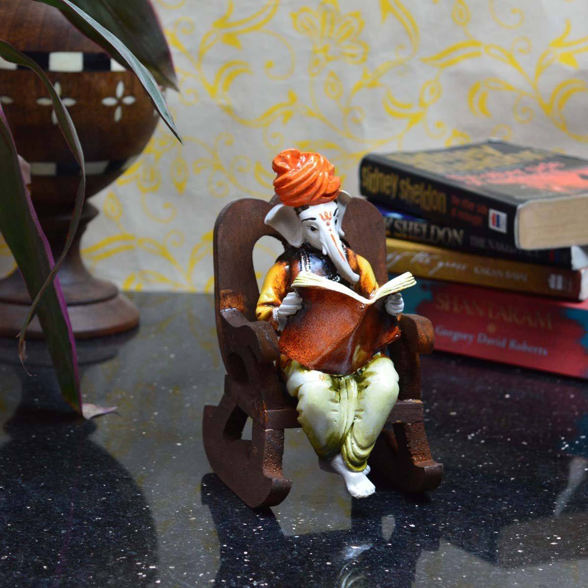 Lord Ganesha Reading Book on Wooden Chair (LxWxH - 4INx5INx6.5IN) - YuvaFlowers