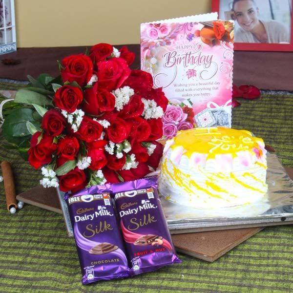Roses with Pineapple Cake and Cadbury Silk for Birthday - YuvaFlowers